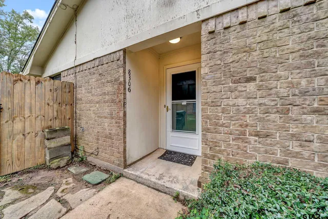a view of front door of house with stairs