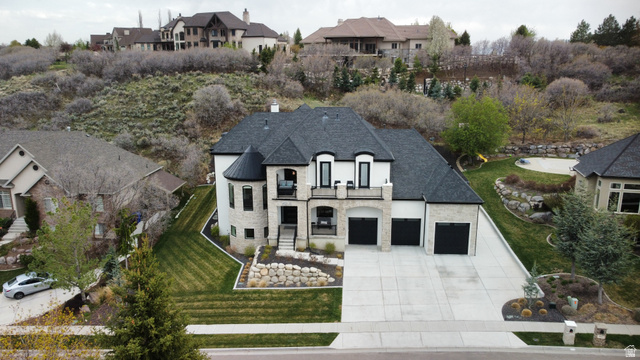 614 East High Lane Alpine, UT 84004 - Photo 22 of 75 French provincial home with stone siding, a residential view, concrete driveway, a balcony, and a chimney