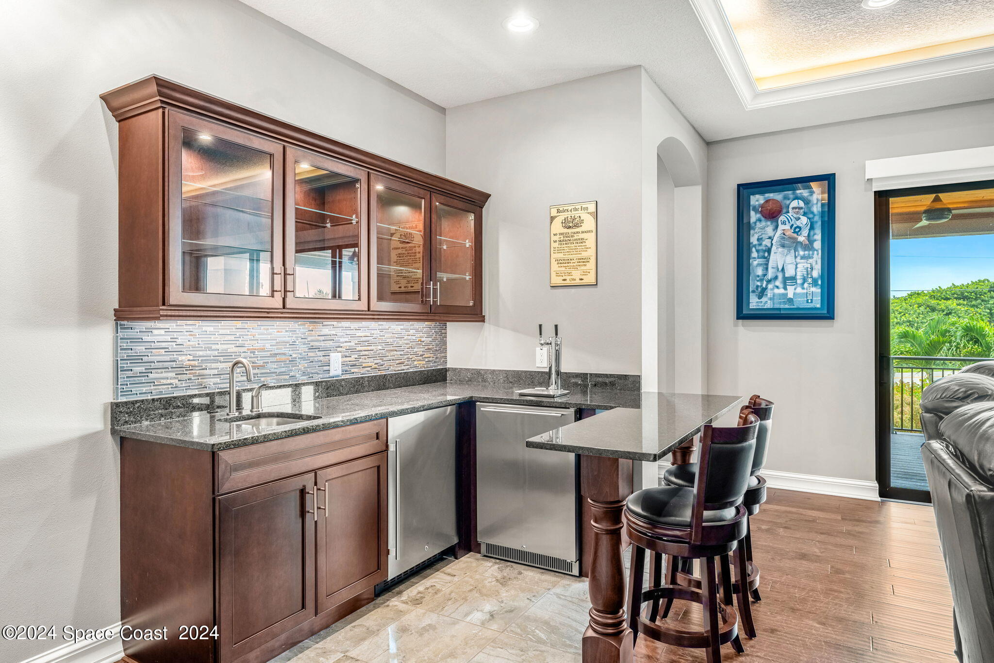 213 Loggerhead Drive Melbourne Beach, FL 32951 - Photo 35 of 58 a kitchen with a stove a sink and chairs