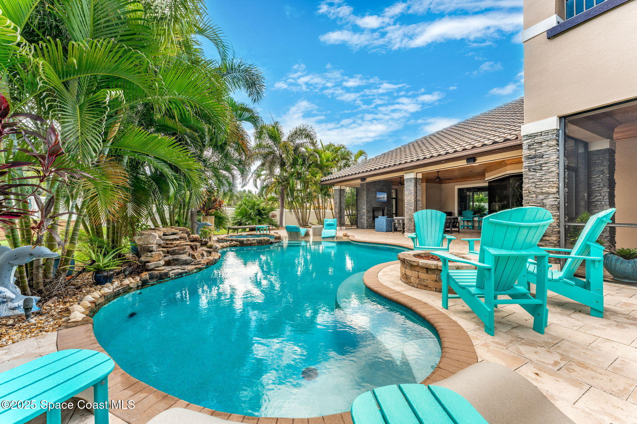 213 Loggerhead Drive Melbourne Beach, FL 32951 - Photo 46 of 58 a view of a swimming pool with chairs
