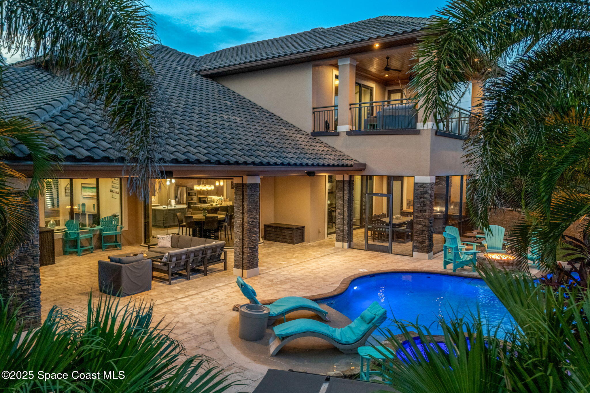 213 Loggerhead Drive Melbourne Beach, FL 32951 - Photo 47 of 58 a patio with couches table and chairs and potted plants