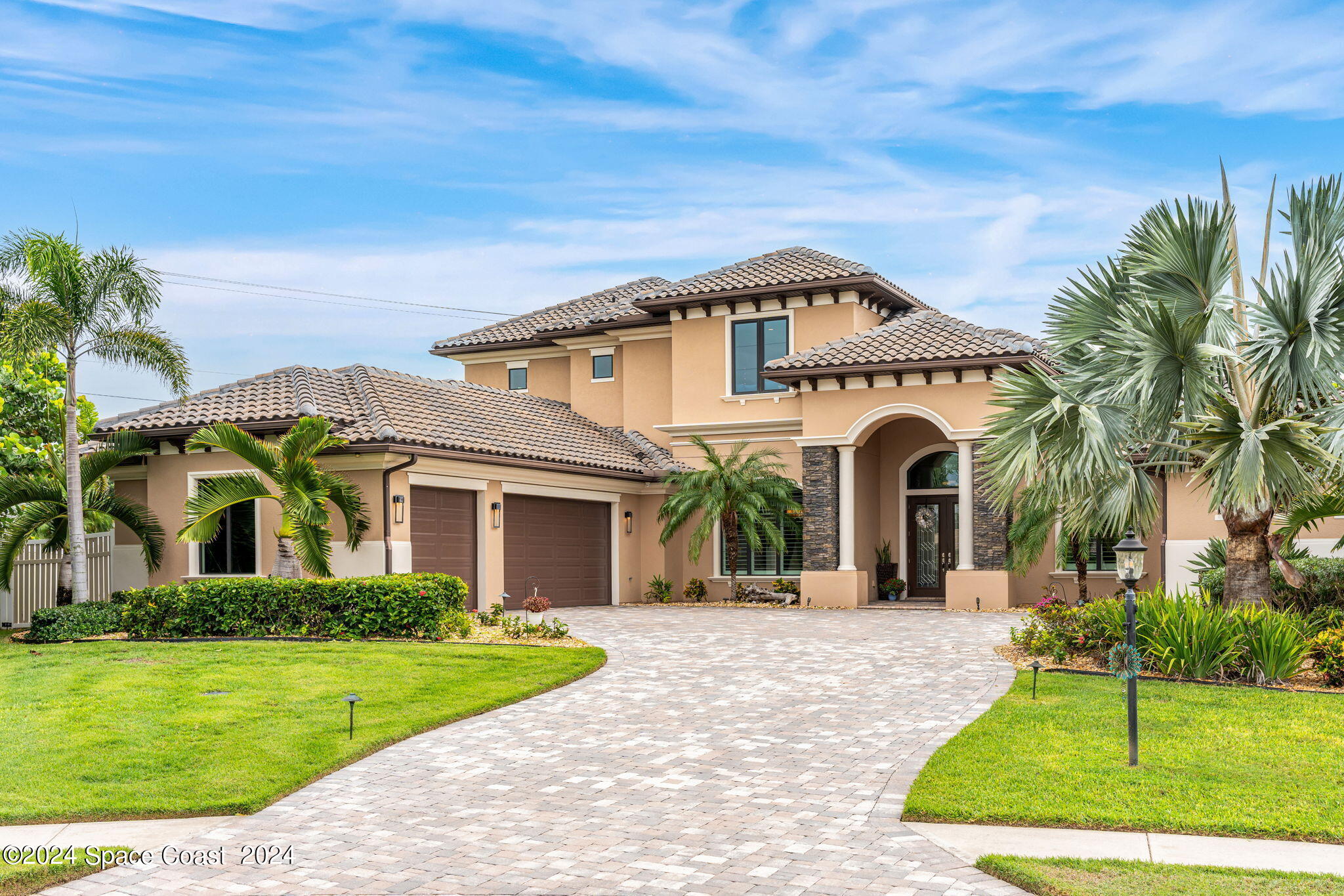 213 Loggerhead Drive Melbourne Beach, FL 32951 - Photo 55 of 58 a view of a white house with a small yard and palm trees
