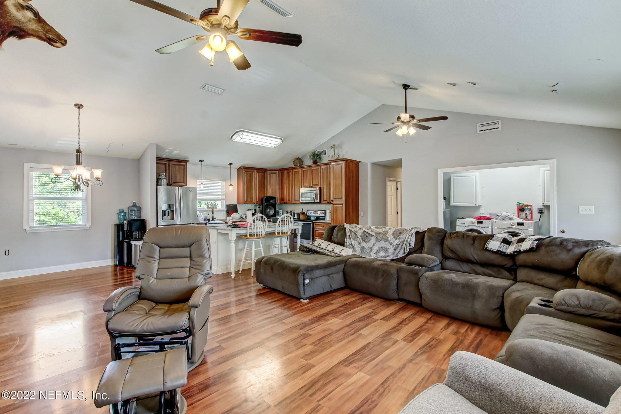 75004 Edwards Road Yulee, FL 32097 - Photo 13 of 62 a living room with furniture kitchen view and a chandelier