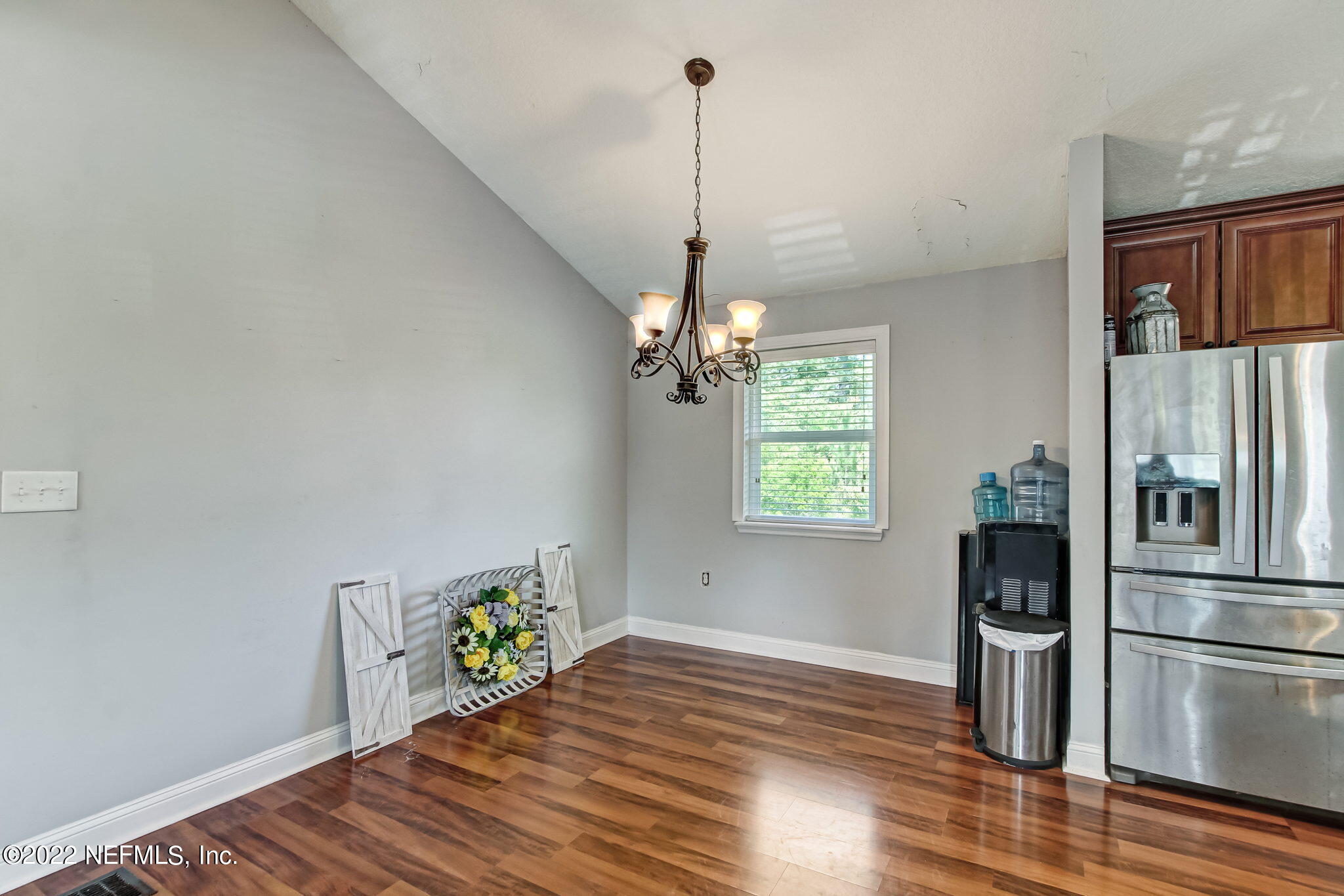 75004 Edwards Road Yulee, FL 32097 - Photo 14 of 62 a kitchen with a refrigerator and a wooden floor