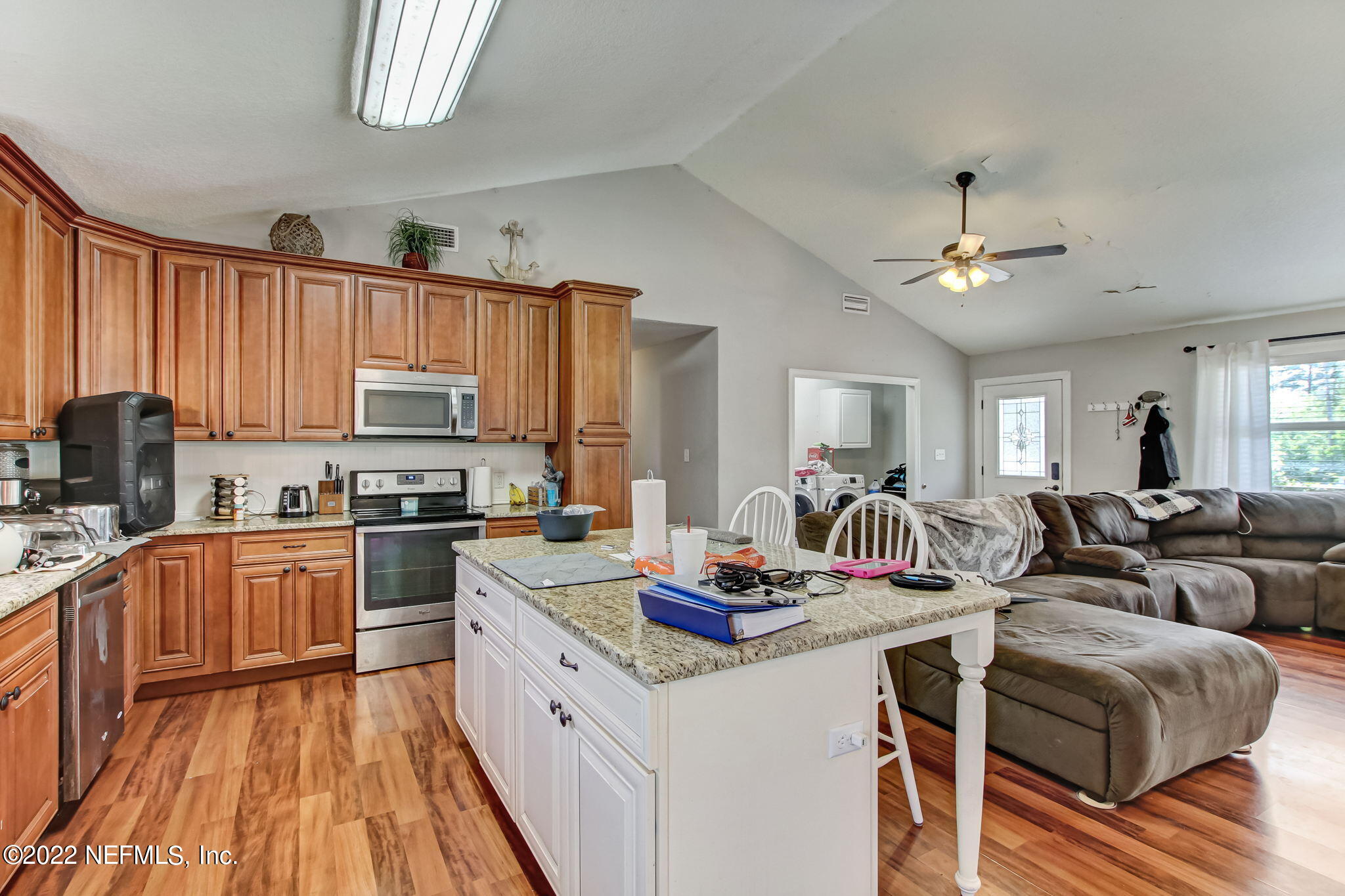 75004 Edwards Road Yulee, FL 32097 - Photo 16 of 62 a kitchen with stainless steel appliances granite countertop a stove refrigerator and cabinets