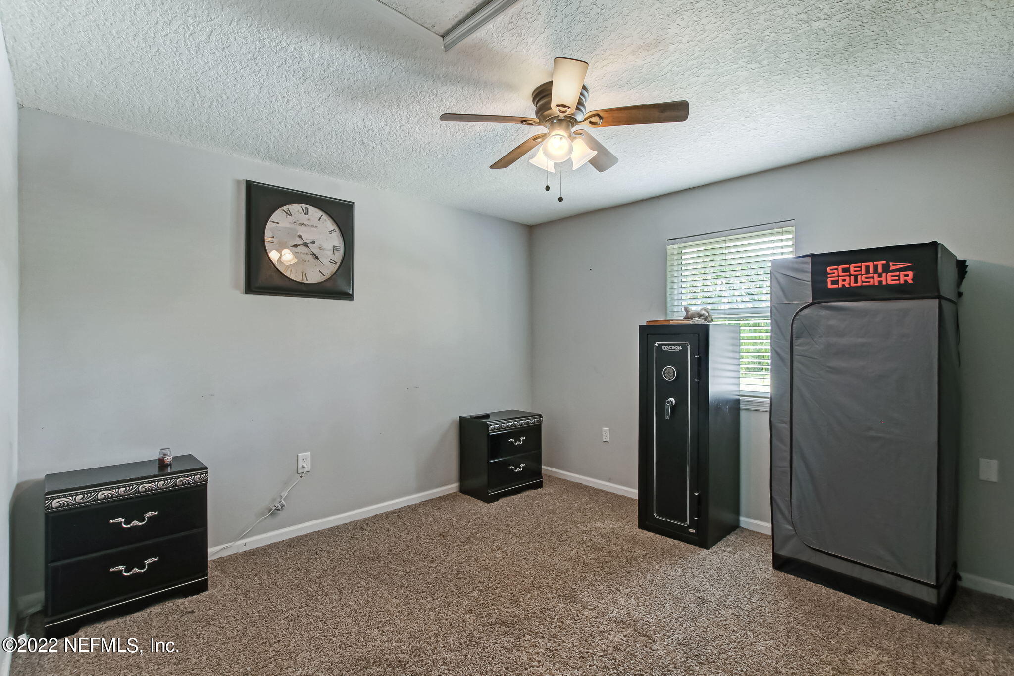 75004 Edwards Road Yulee, FL 32097 - Photo 18 of 62 a view of a livingroom with a ceiling fan and a wooden closet