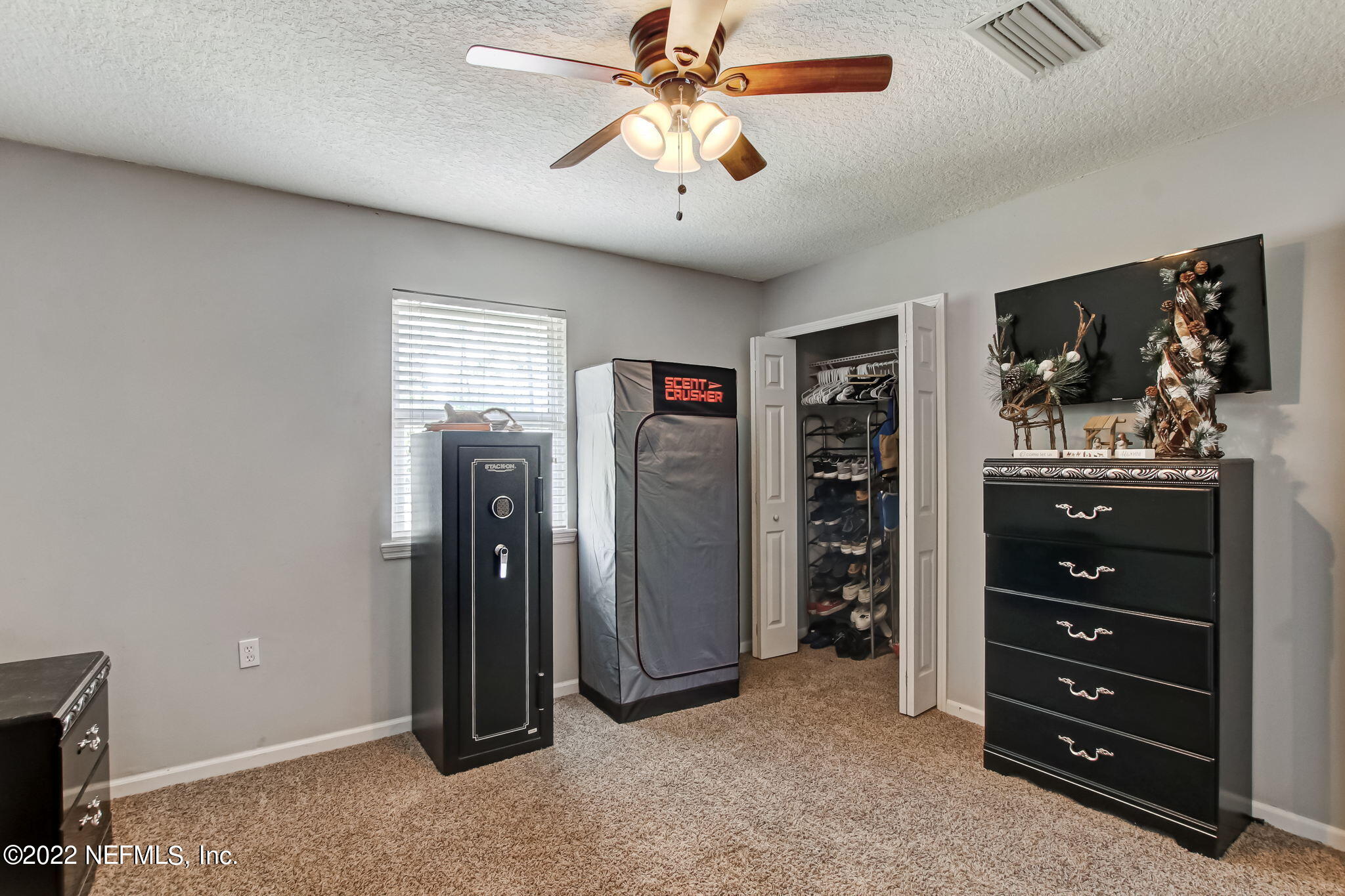 75004 Edwards Road Yulee, FL 32097 - Photo 19 of 62 a view of a livingroom with a cabinet and a flat screen tv