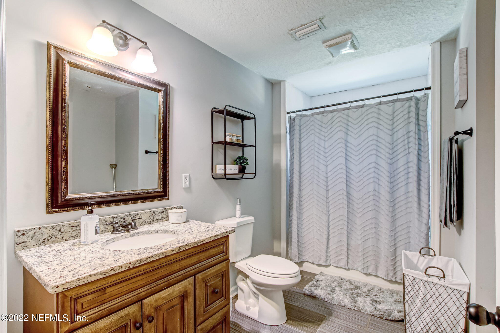 75004 Edwards Road Yulee, FL 32097 - Photo 20 of 62 a bathroom with a granite countertop sink toilet and shower