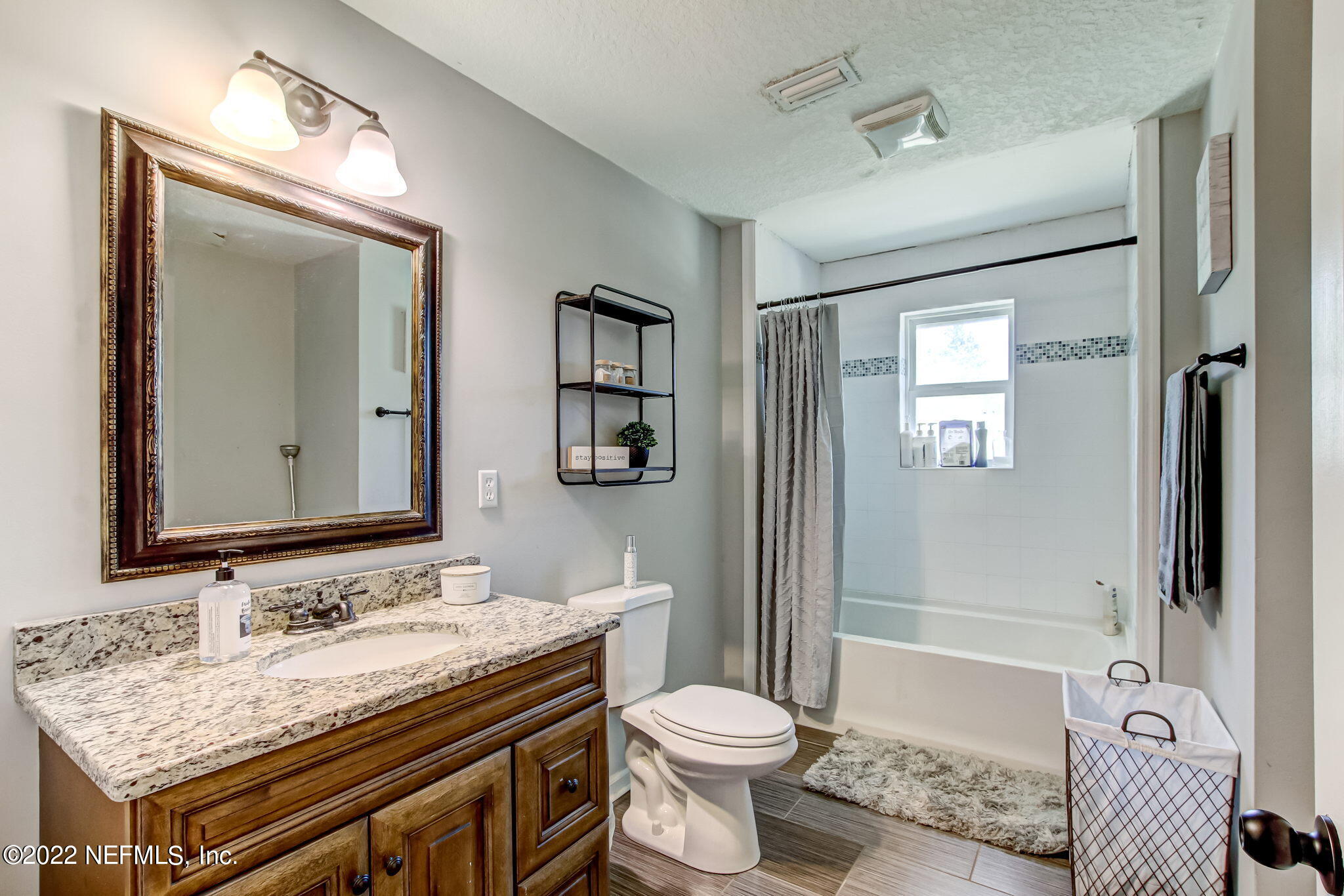 75004 Edwards Road Yulee, FL 32097 - Photo 21 of 62 a bathroom with a granite countertop sink toilet and shower