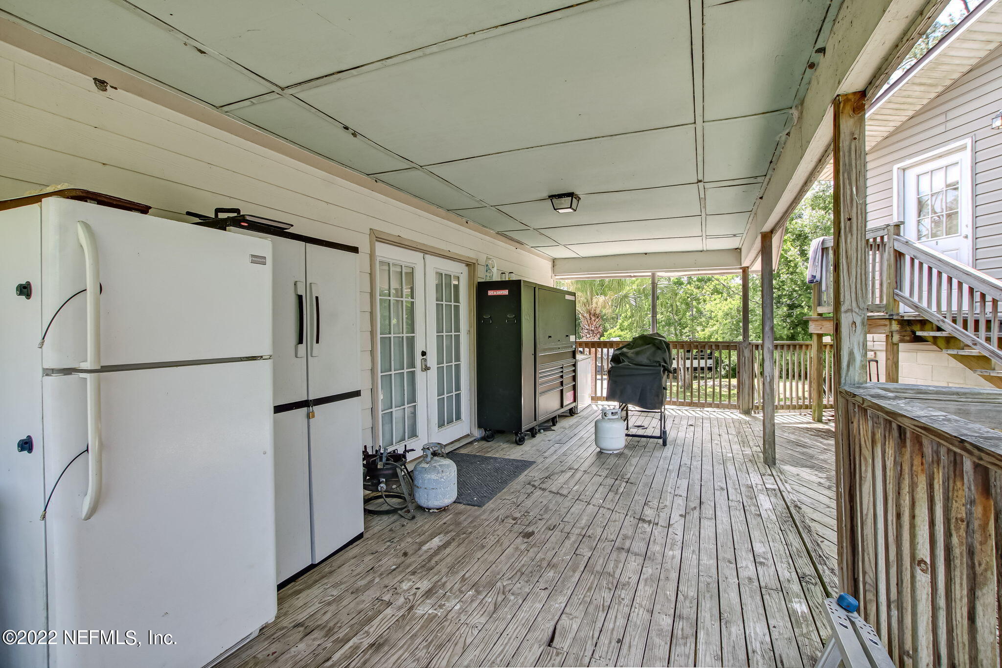 75004 Edwards Road Yulee, FL 32097 - Photo 34 of 62 a view of a porch with wooden floor and furniture