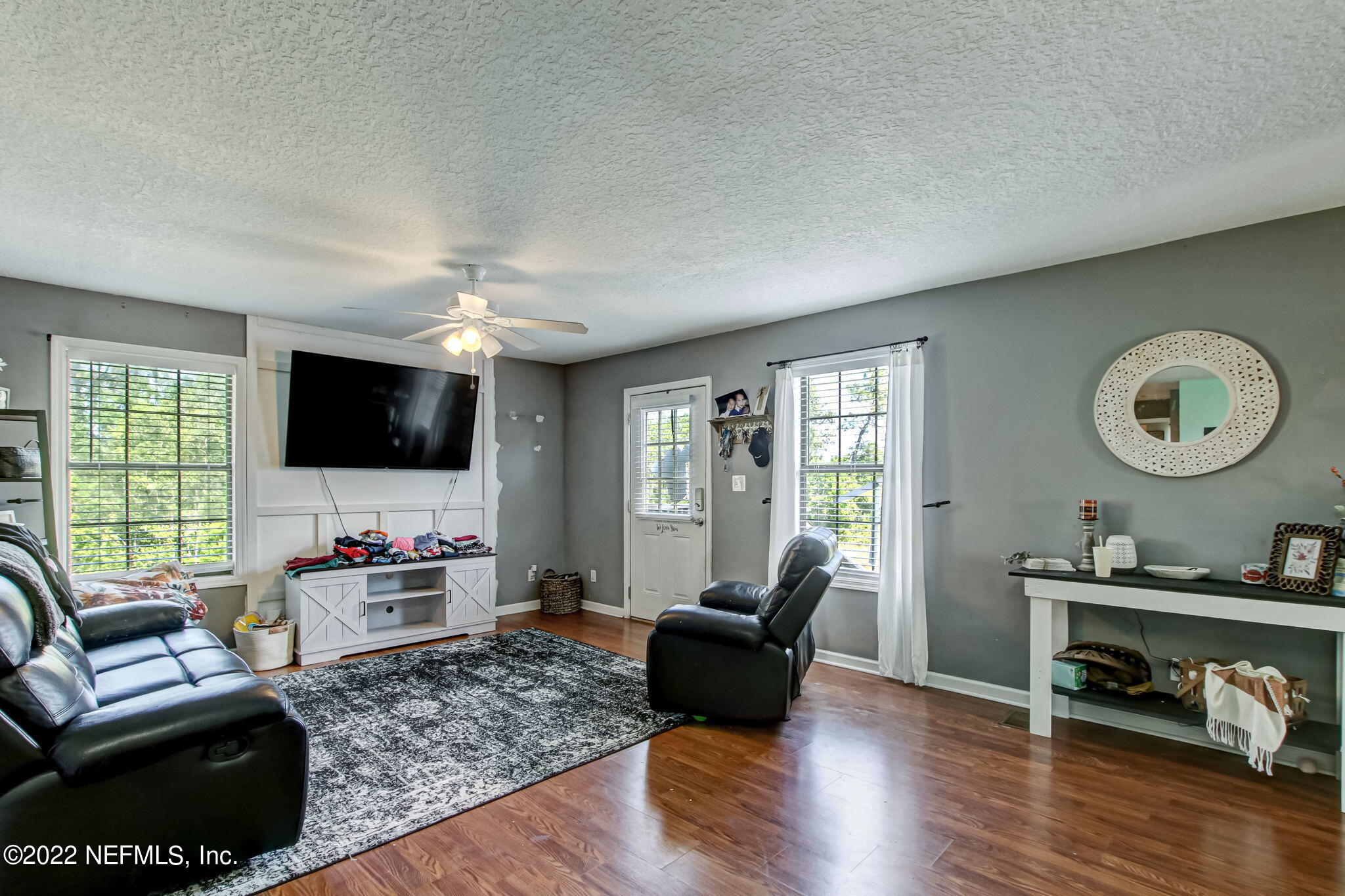 75004 Edwards Road Yulee, FL 32097 - Photo 41 of 62 a living room with furniture and a flat screen tv
