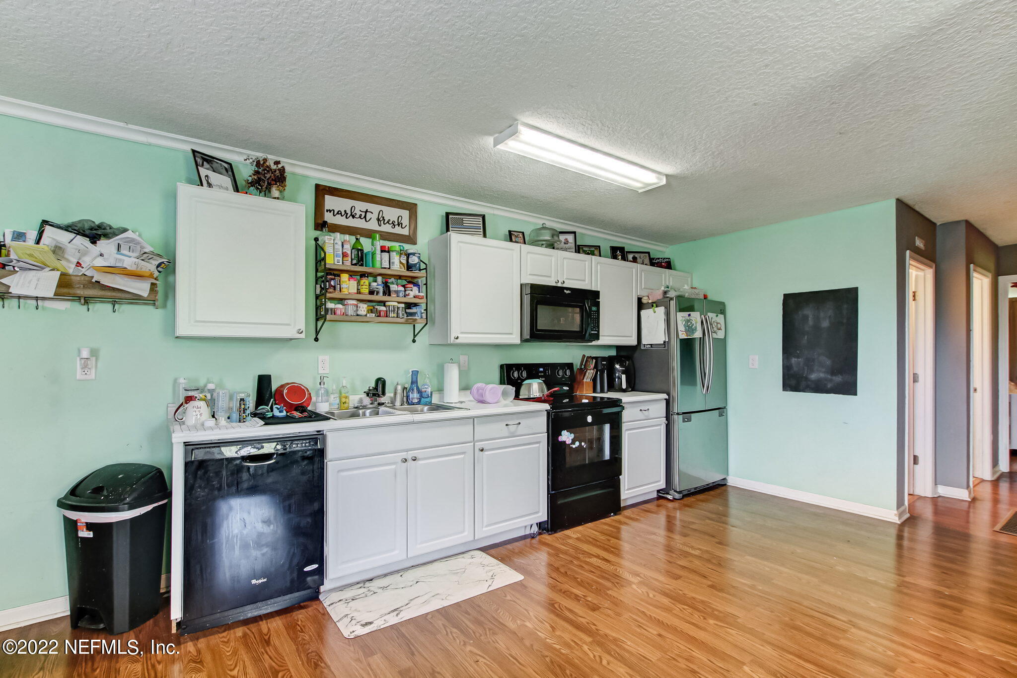 75004 Edwards Road Yulee, FL 32097 - Photo 43 of 62 a kitchen with a stove and wooden floor