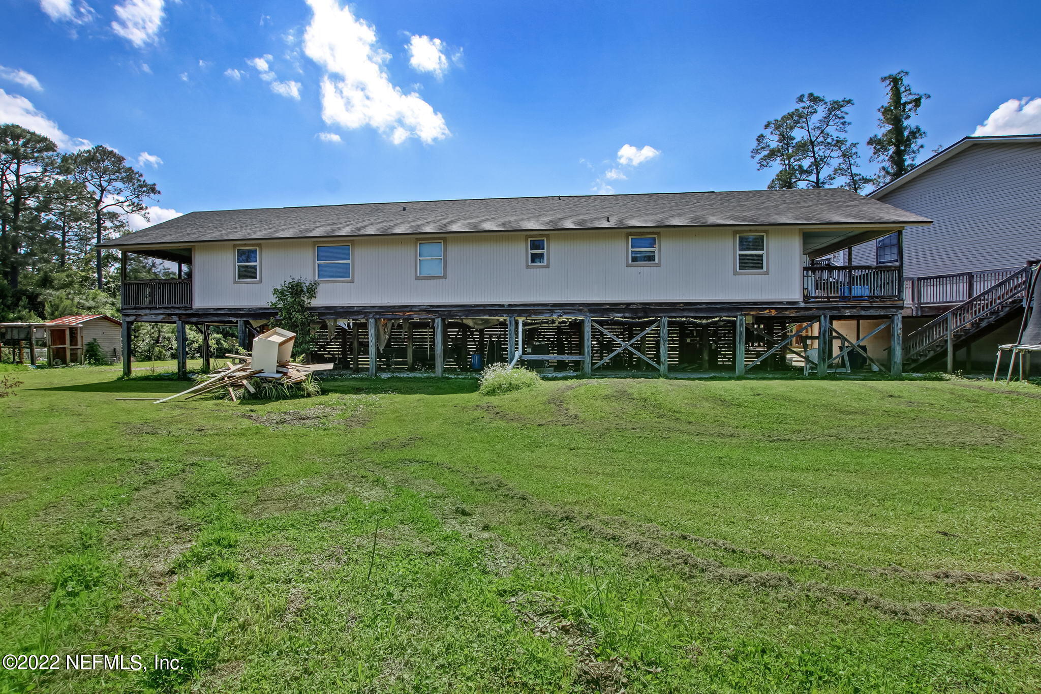 75004 Edwards Road Yulee, FL 32097 - Photo 55 of 62 a front view of a house with a yard table and chairs