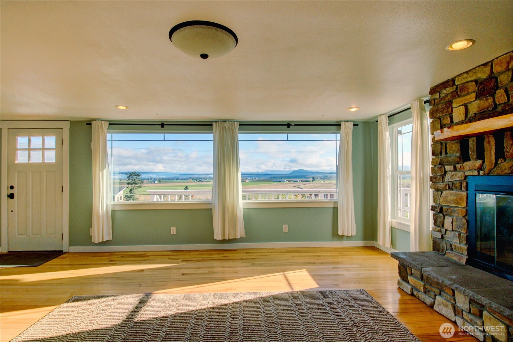 18122 Best Road Mount Vernon, WA 98273 - Photo 12 of 40 a view of an empty room with a fireplace and a window