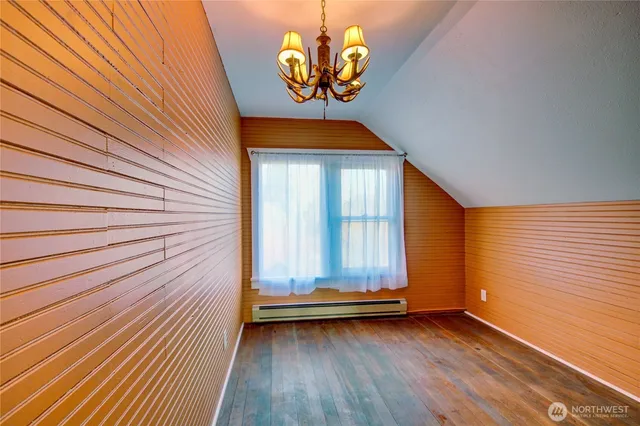 a view of a room with wooden floor and window