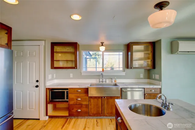 a kitchen with stainless steel appliances a sink stove and cabinets