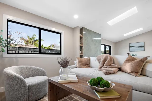 a bathroom with a tub a sink and a large mirror