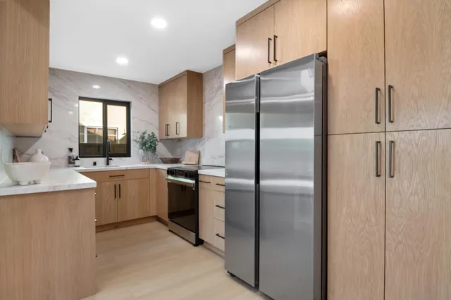 a living room with furniture and potted plant