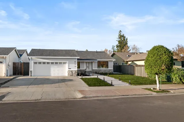 a front view of a house with a yard and garage
