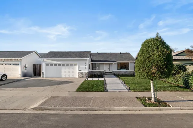 a view of a backyard with a garden and bench