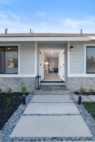 a backyard of a house with table and chairs