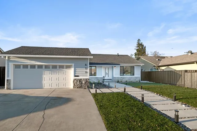 a view of a chair and tables in the patio