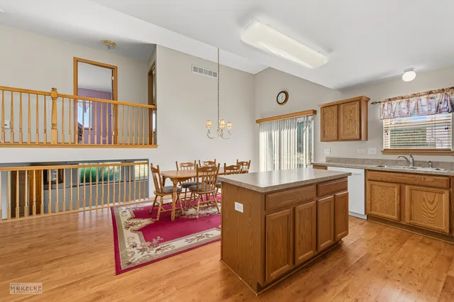 a kitchen with granite countertop a sink and a stove