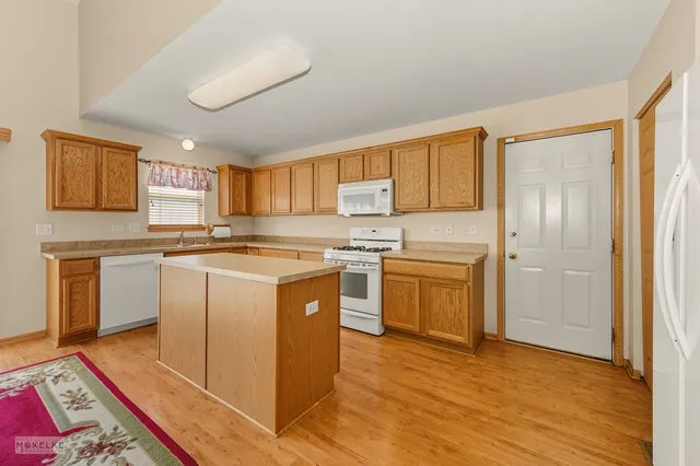 a kitchen with stainless steel appliances granite countertop a stove a sink dishwasher and a refrigerator