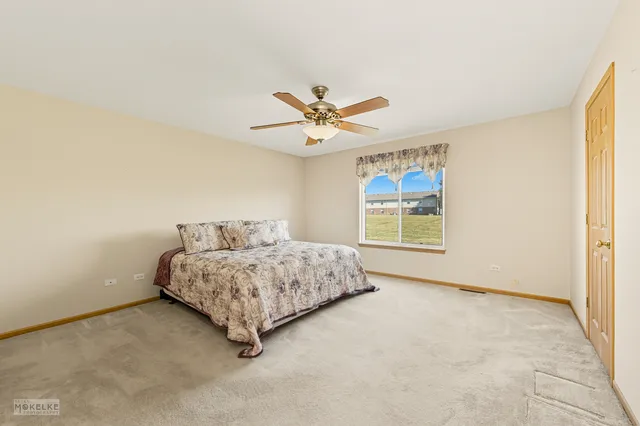 a spacious bedroom with a bed and window