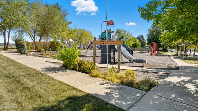a view of a house with backyard and sitting area