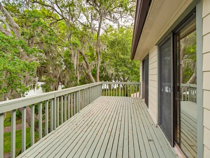 a front view of a house with a garden and deck