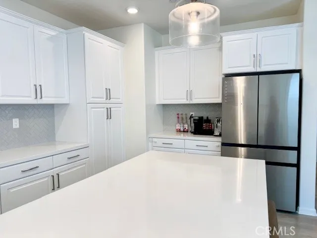 a kitchen with stainless steel appliances a refrigerator sink and cabinets