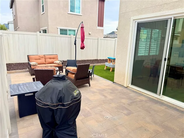 a balcony with table and chairs