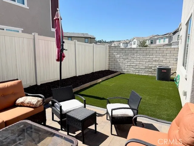 a backyard of a house with table and chairs