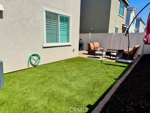 a view of a patio with table and chairs and potted plants