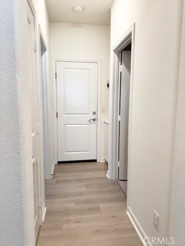 a view of a hallway with wooden floor