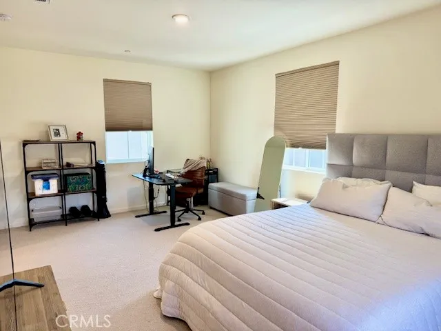 a bedroom with two beds and a lamp