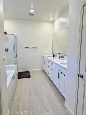 a bathroom with a double vanity sink and mirror