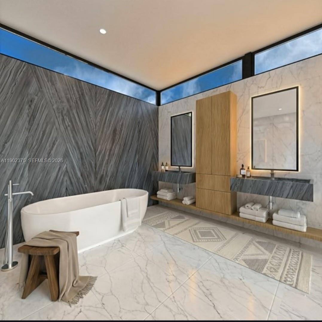 5850 Southwest 93rd Street Pinecrest, FL 33156 - Photo 8 of 12 a bathroom with a tub a sink and a large mirror