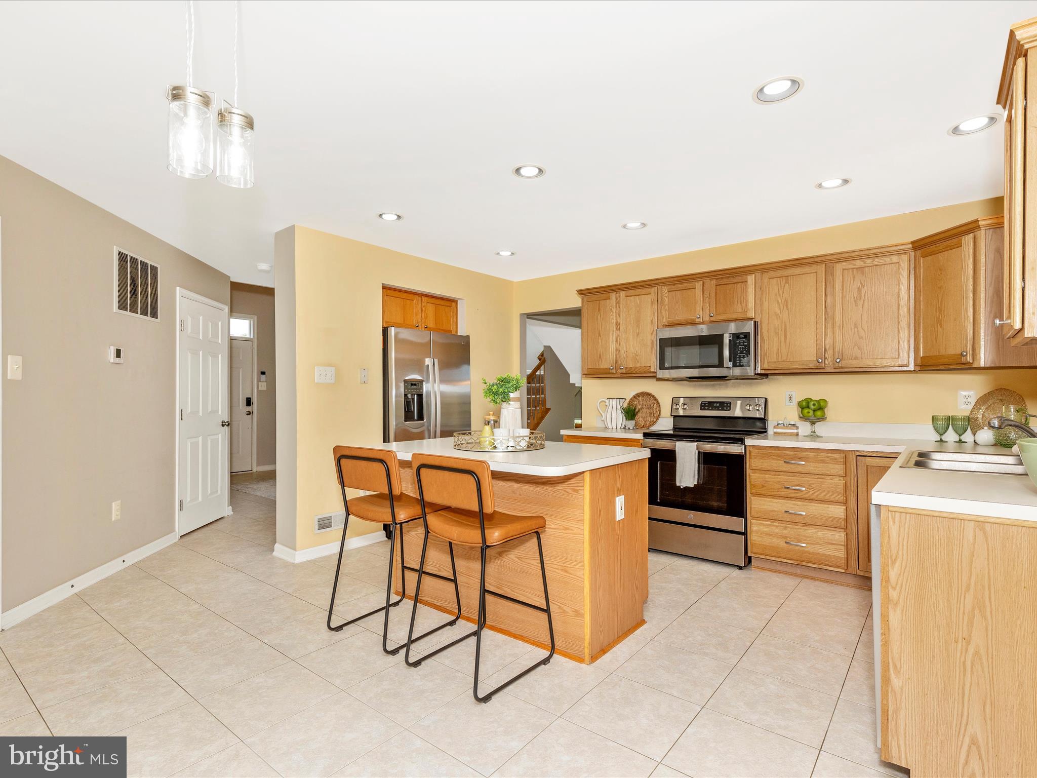 1402 Marian Way Mount Airy, MD 21771 - Photo 15 of 66 a kitchen with stainless steel appliances kitchen island granite countertop a sink and cabinets
