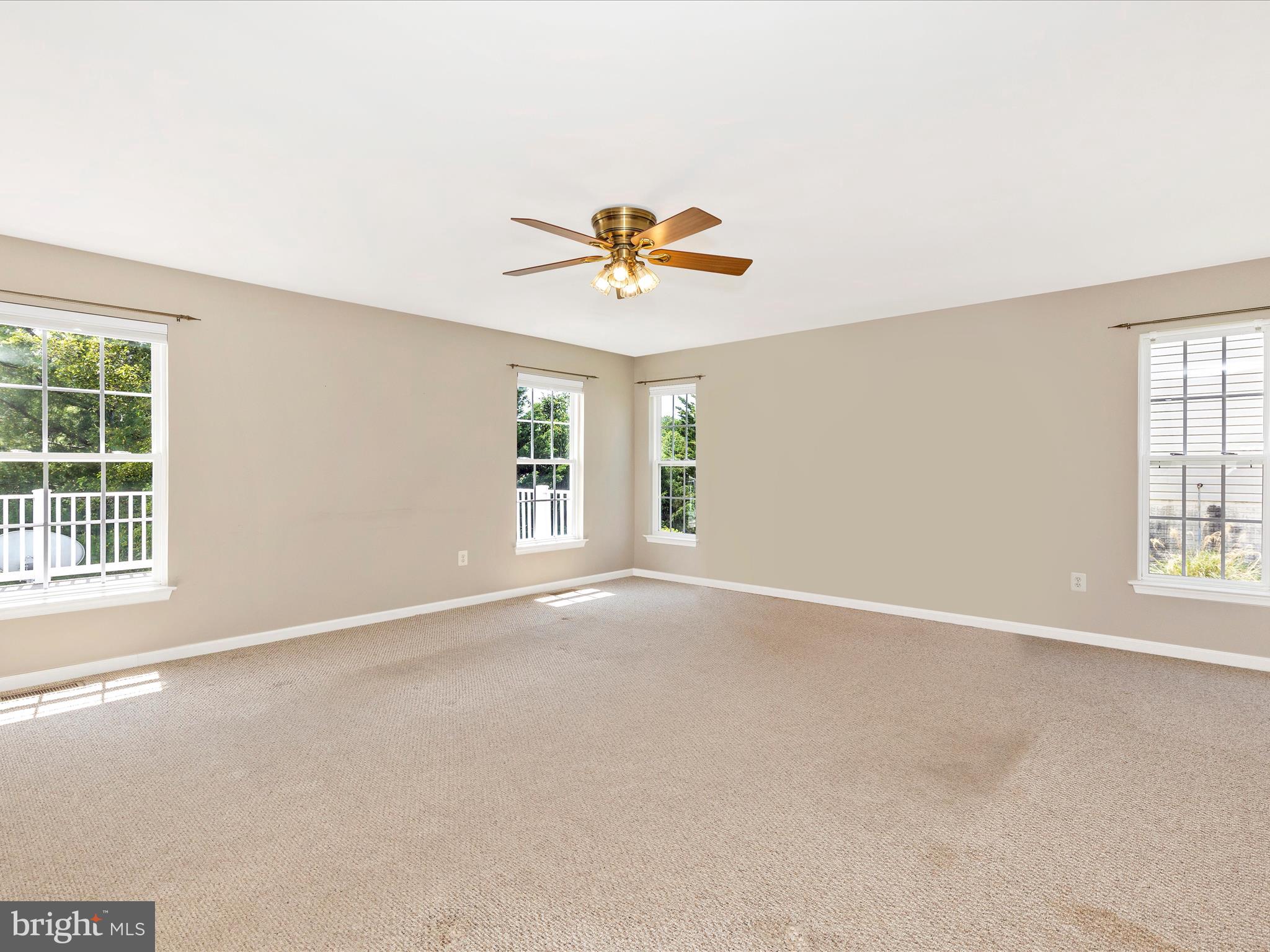 1402 Marian Way Mount Airy, MD 21771 - Photo 22 of 66 an empty room with windows and a chandelier fan