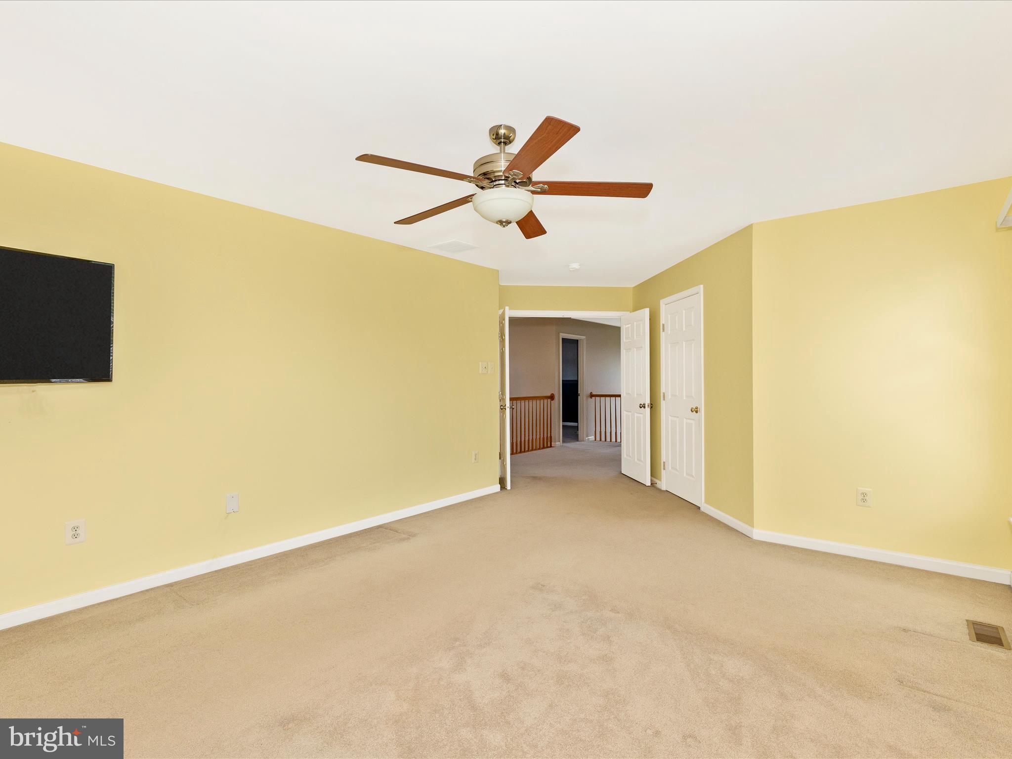 1402 Marian Way Mount Airy, MD 21771 - Photo 29 of 66 a view of a room with a ceiling fan and a refrigerator