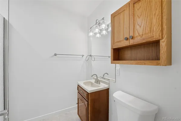 a bathroom with a sink a toilet and mirror