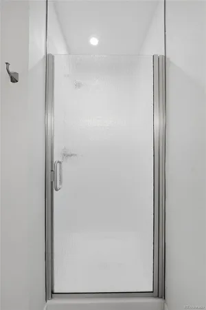 a bathroom with a glass shower door