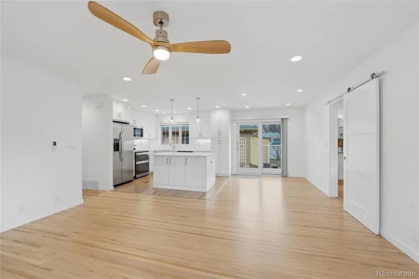 a view of a kitchen with a sink and wooden floor