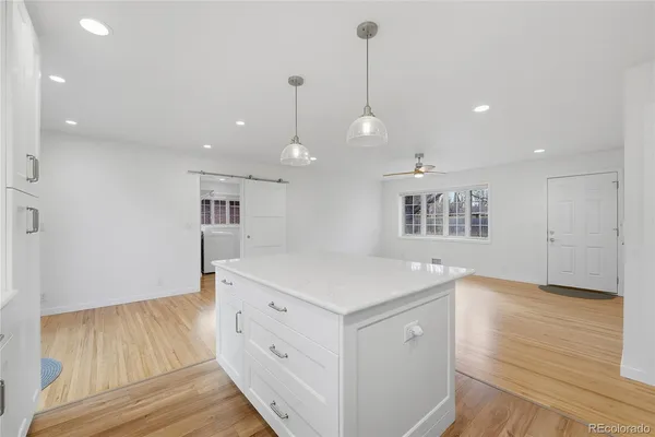 a kitchen with a wooden floor and window