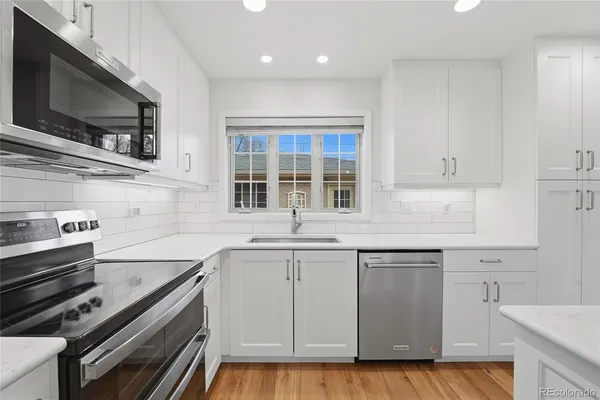 a kitchen with a sink stove and microwave