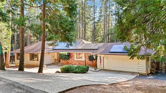 a view of a house with a yard and sitting area