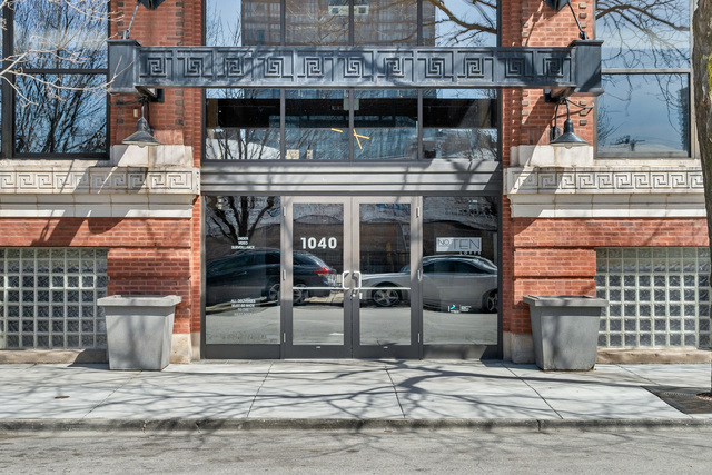 1040 West Adams Street, Unit 608 Chicago, IL 60607 - Photo 2 of 24 a front view of a building with glass windows