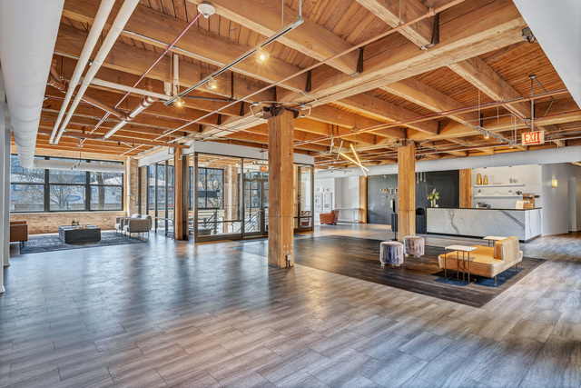 1040 West Adams Street, Unit 608 Chicago, IL 60607 - Photo 5 of 24 a view of a hall with wooden floors